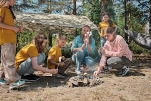 a group of people sitting around a campfire