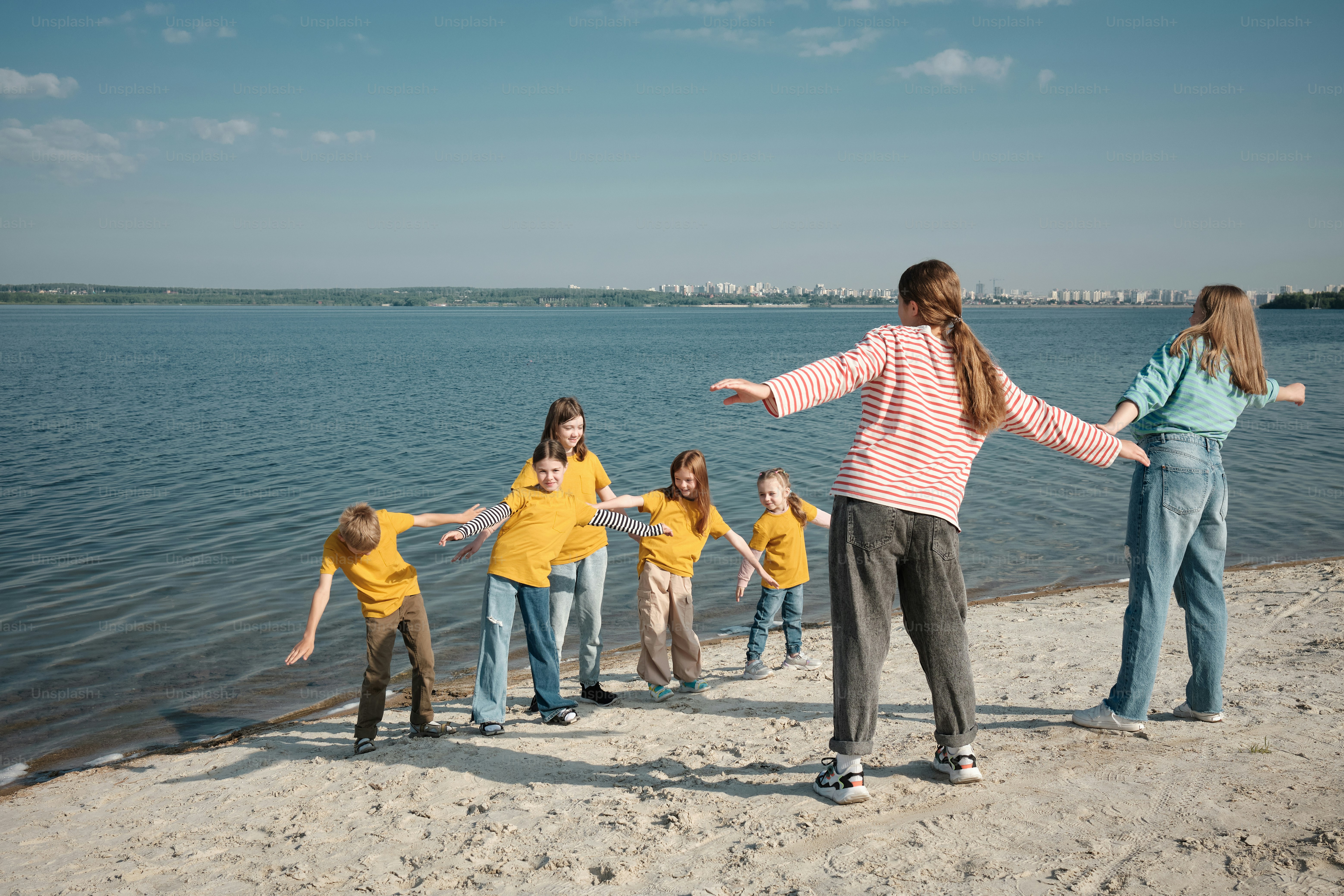 A group of people standing around each other holding bags photo – Camp ...