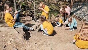 a group of children sitting on the ground next to each other