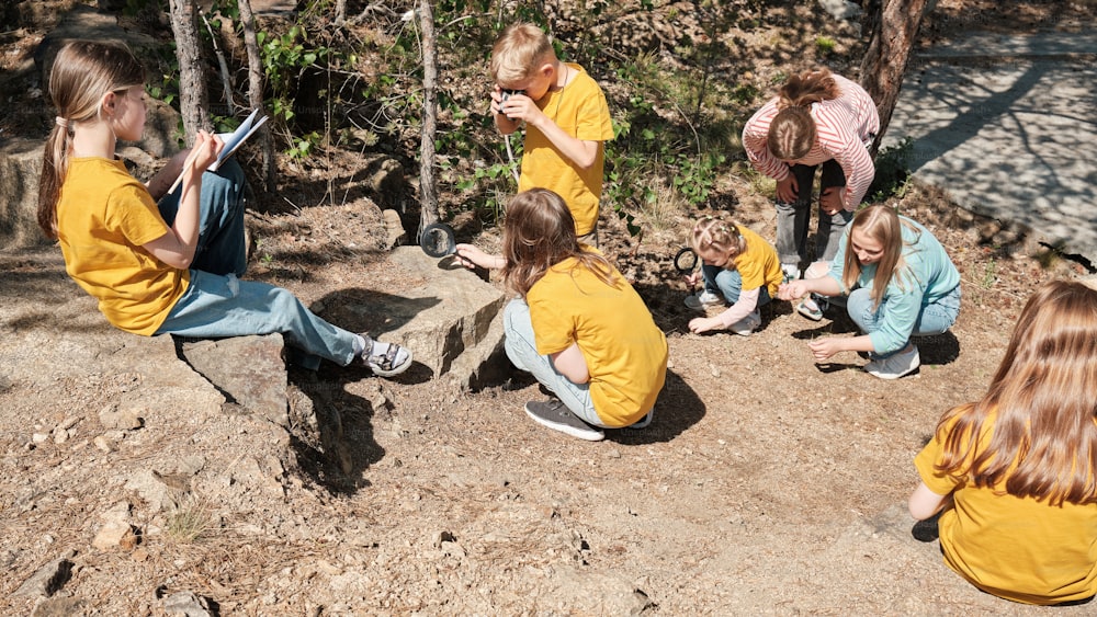 a group of children sitting on the ground next to each other