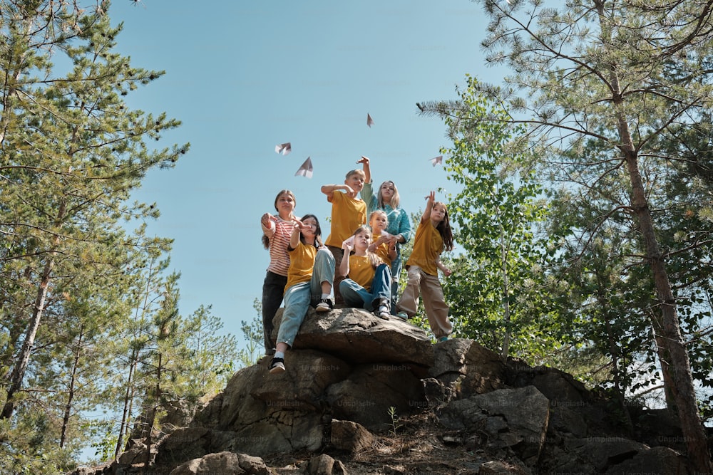 a group of people standing on top of a rock