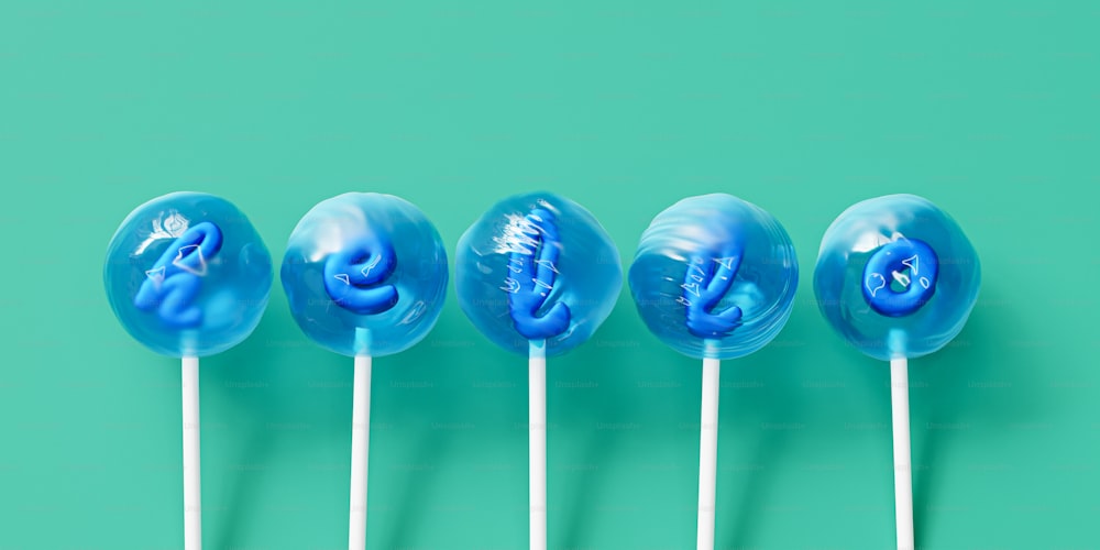 a row of blue lollipops sitting on top of each other