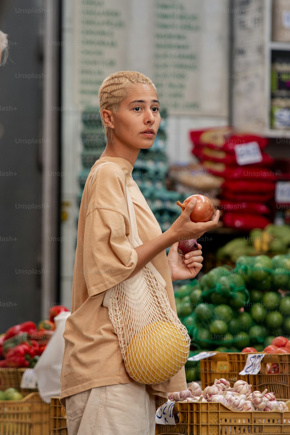 uma mulher segurando uma maçã em um mercado