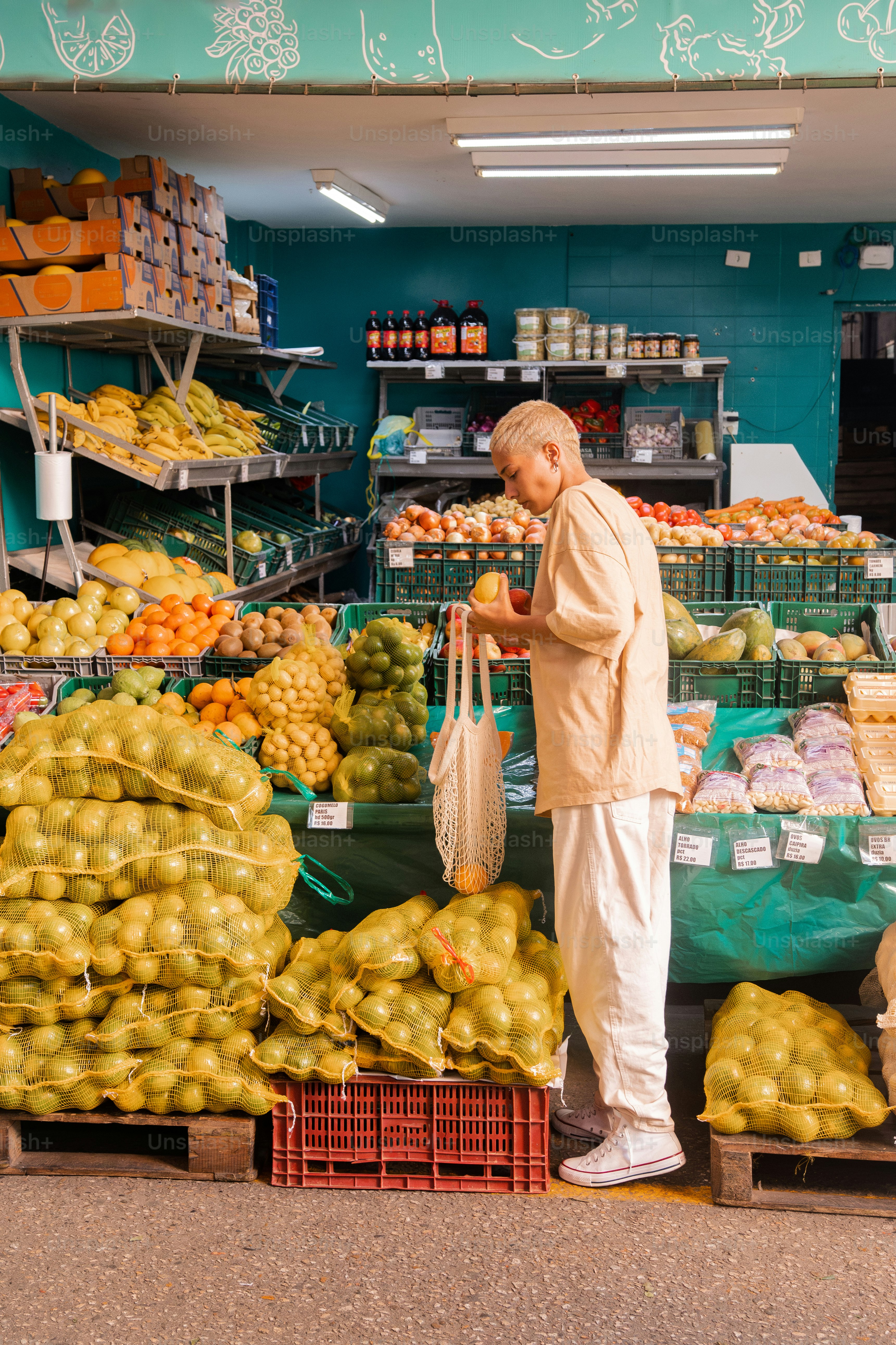 a man standing in front of a fruit stand