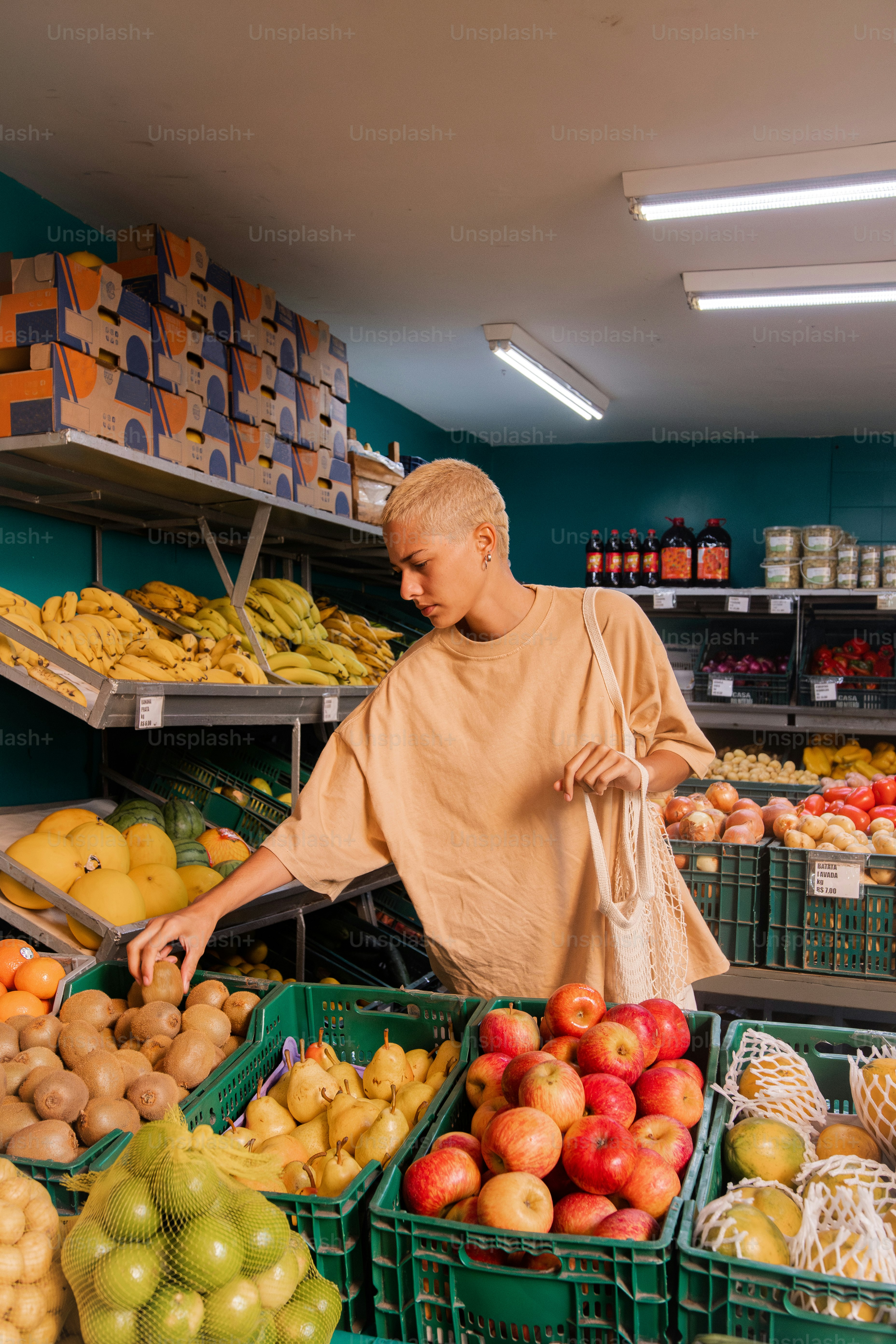 a man standing in front of a display of fruit