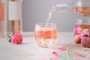 a glass of wine being poured into a glass