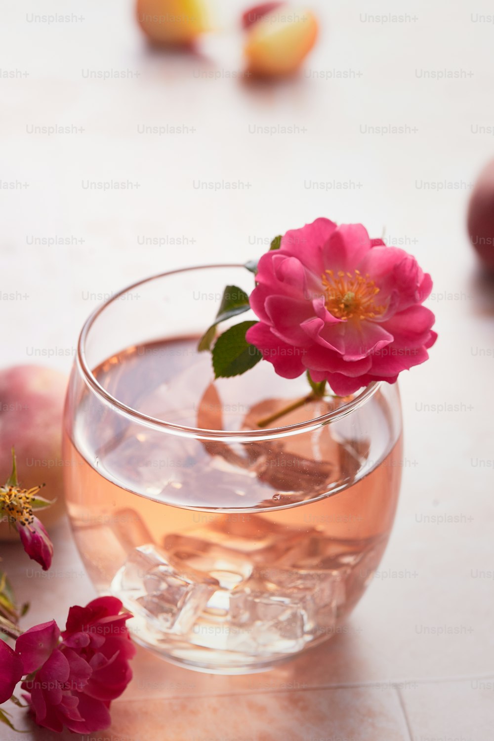 a glass of water with a flower in it