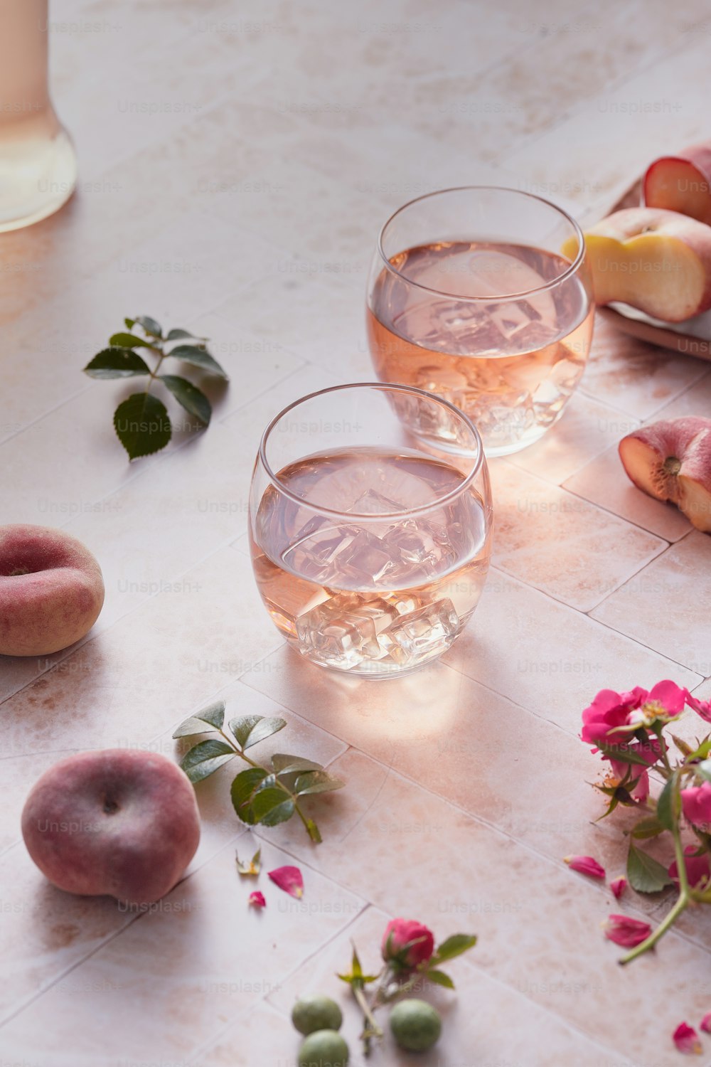 a table topped with glasses of wine and fruit