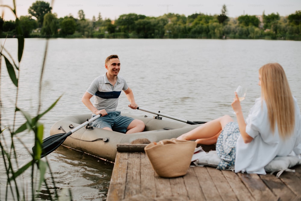 a man and a woman sitting on a raft on a lake