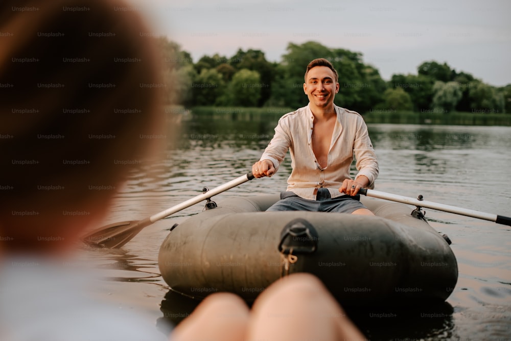 a man sitting on a raft in the water