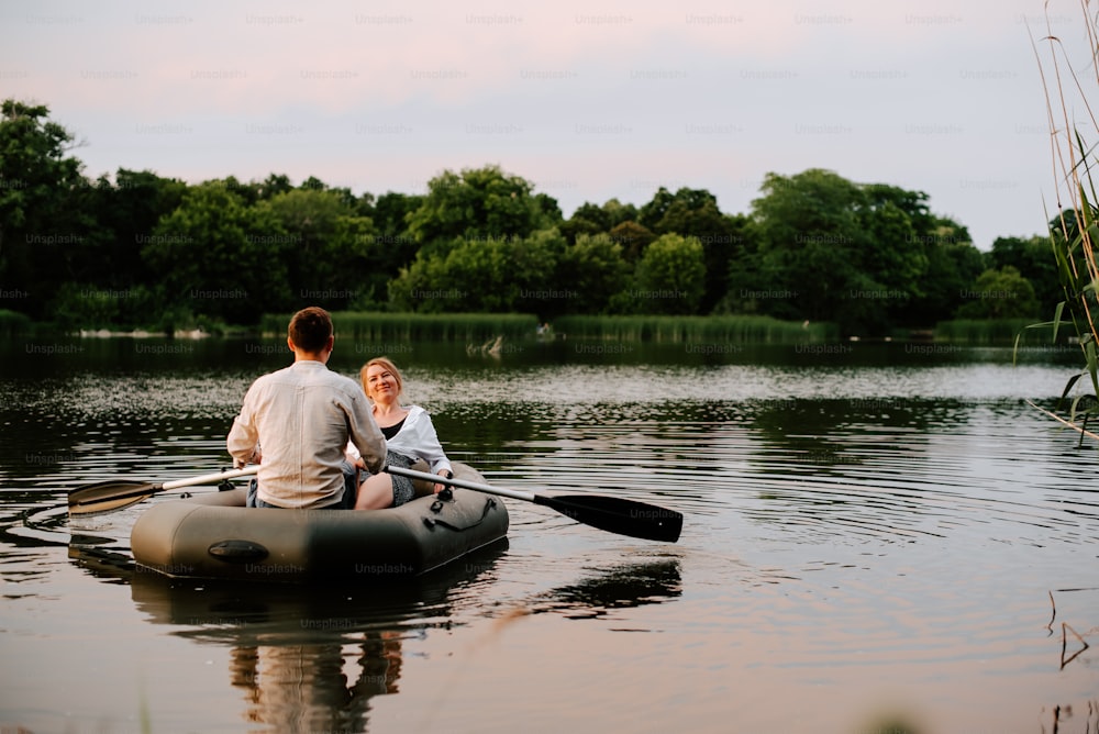 a man and a woman in a boat on a lake