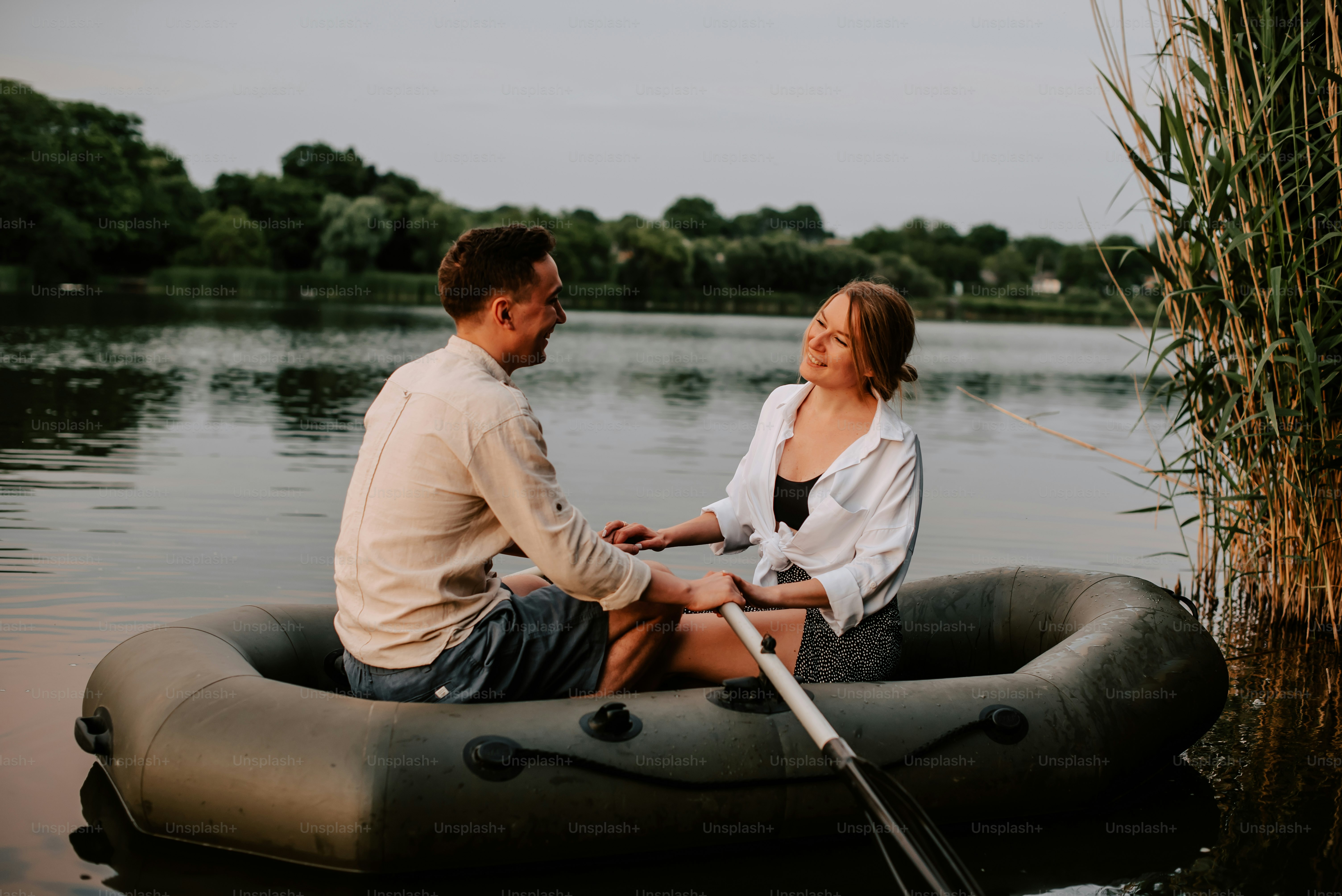 a man and a woman sitting on a raft in the water