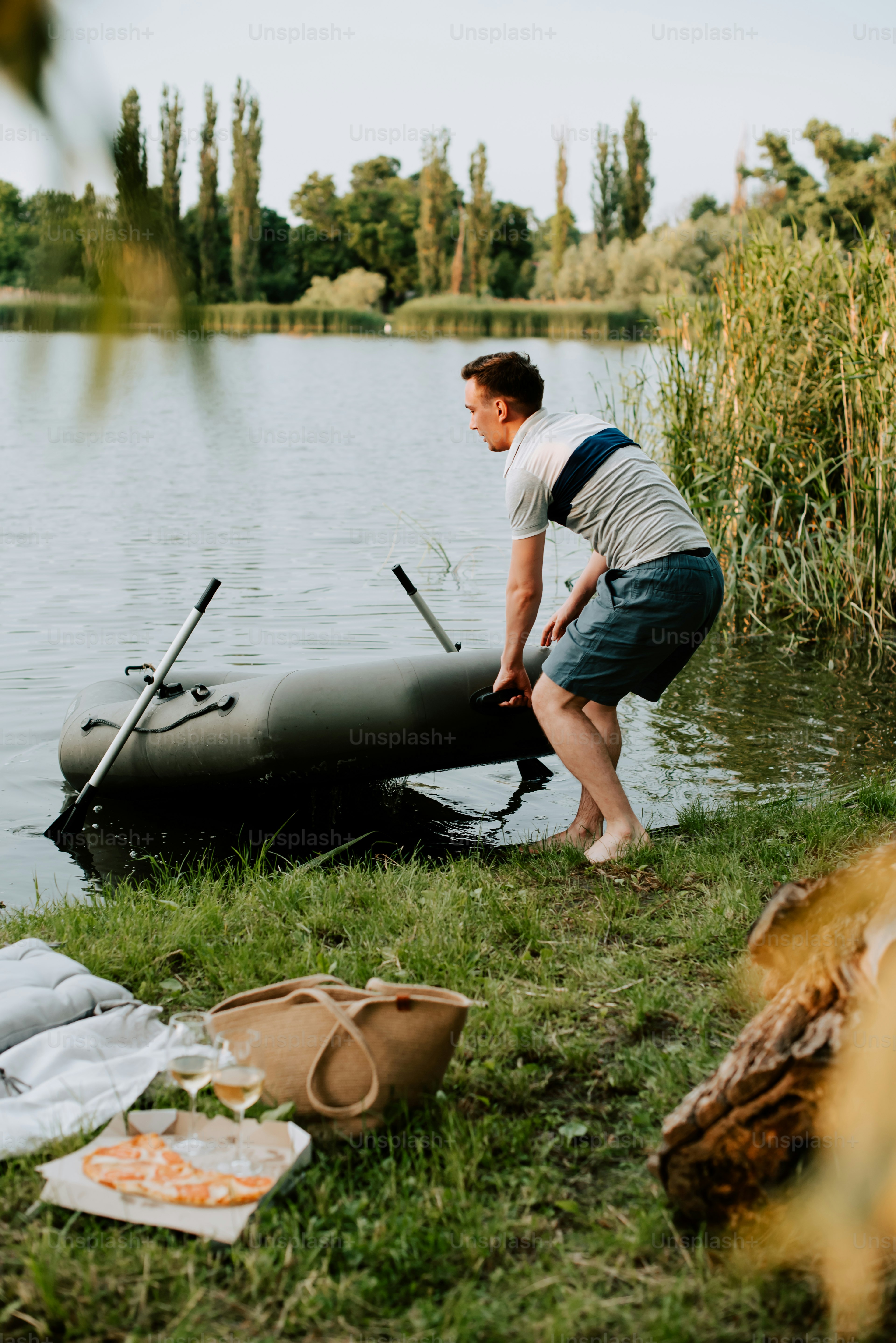 a man standing next to a body of water