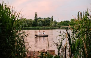 two people in a small boat on a lake