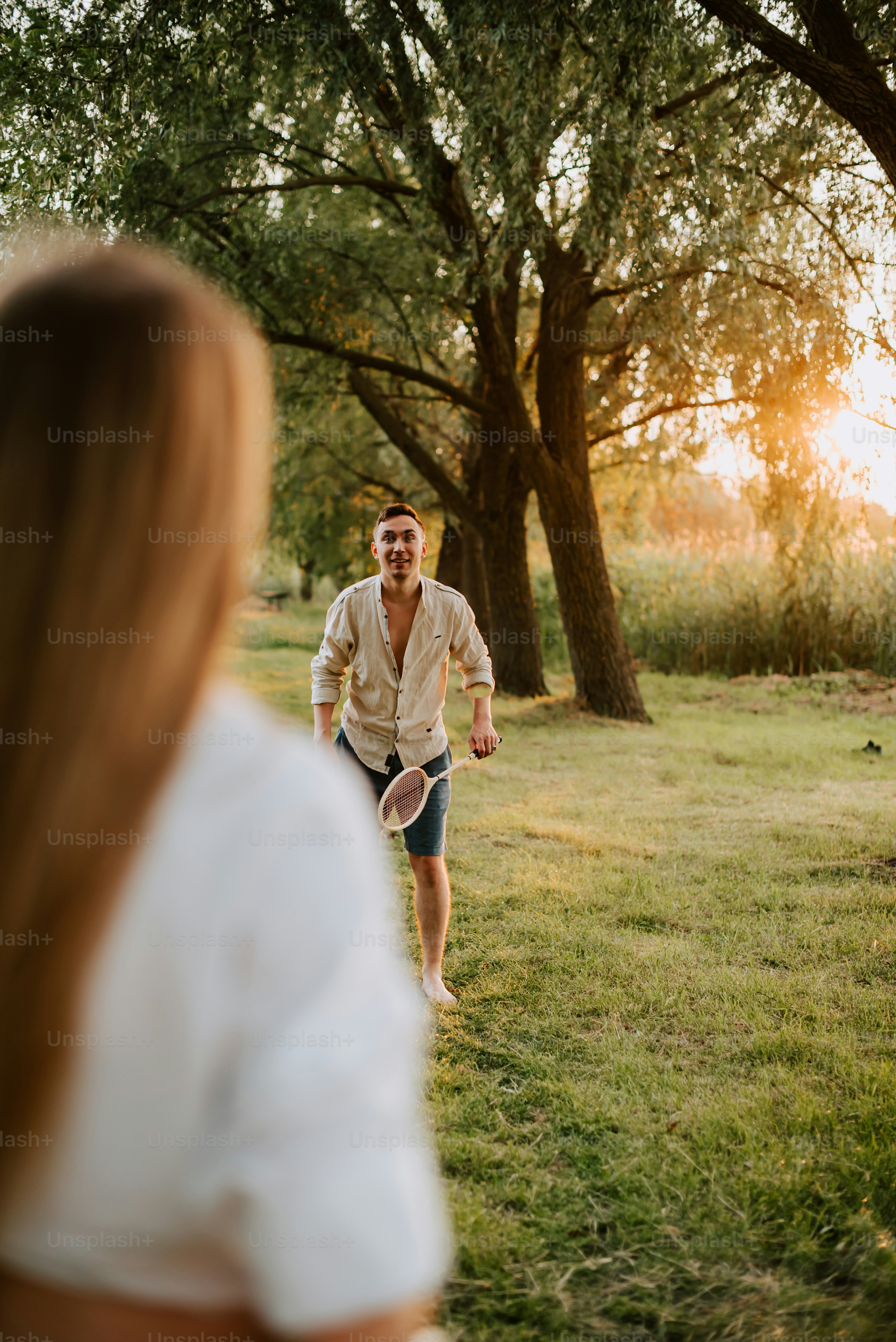 a man and a woman playing frisbee in a field
