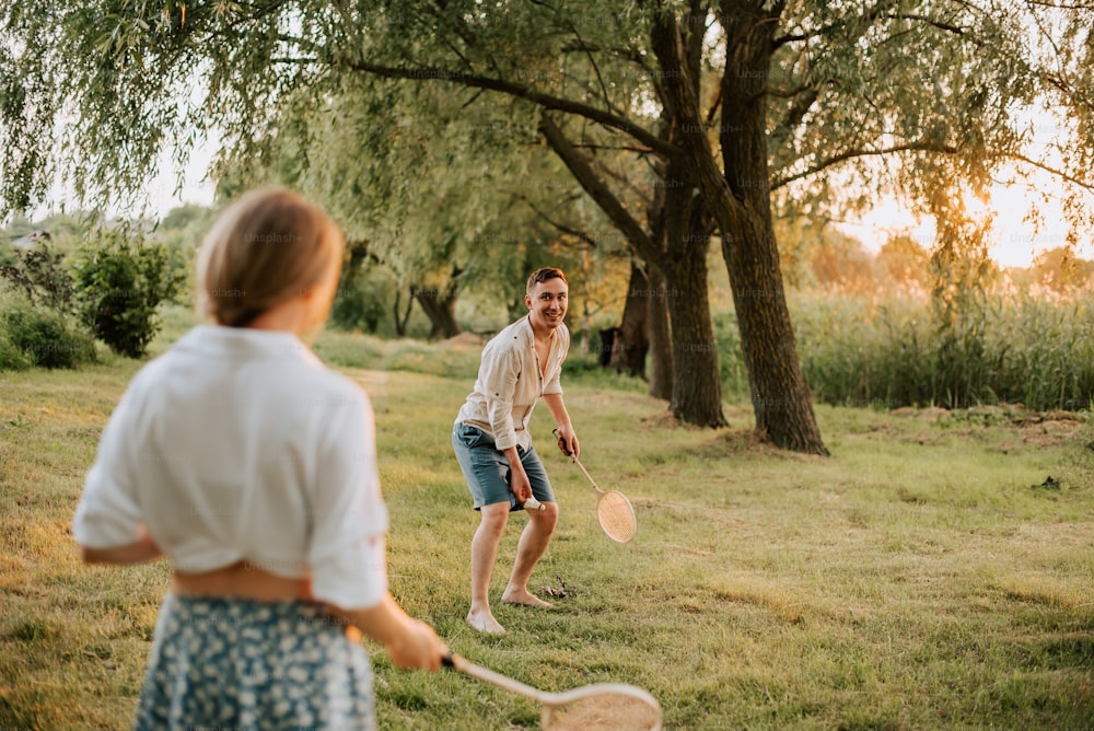 a man and a woman playing a game of badminton