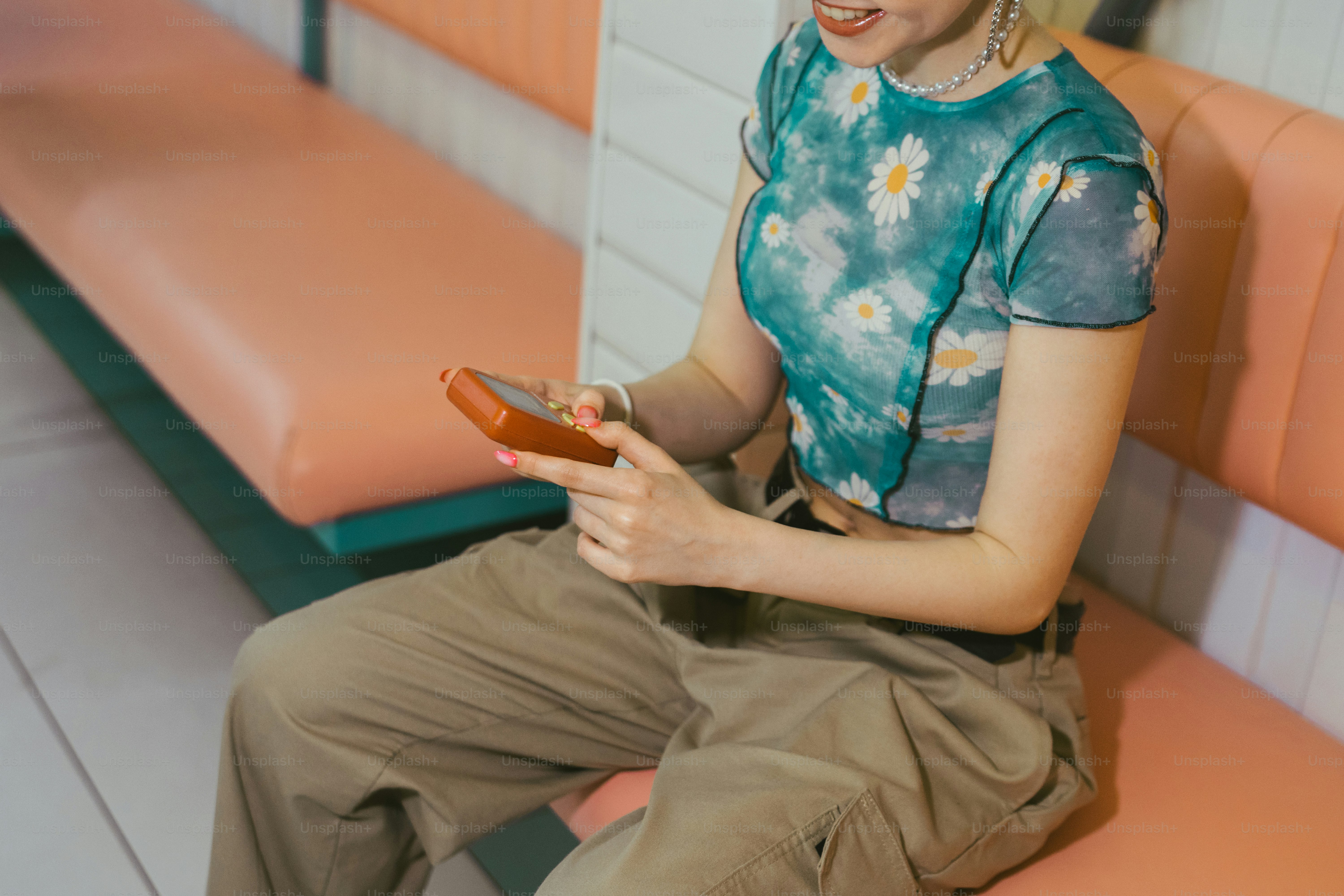 a woman sitting on a bench holding a cell phone