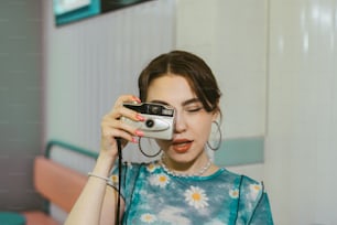 a woman taking a picture of herself with a camera