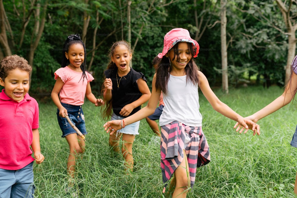 a group of children holding hands in a field