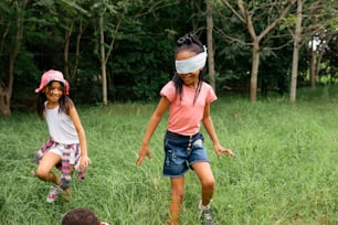 two young girls playing with a frisbee in a field