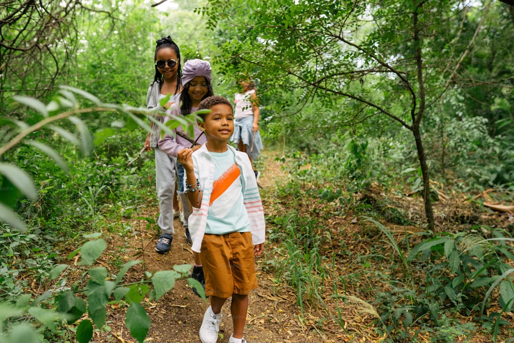 a group of people walking through a forest