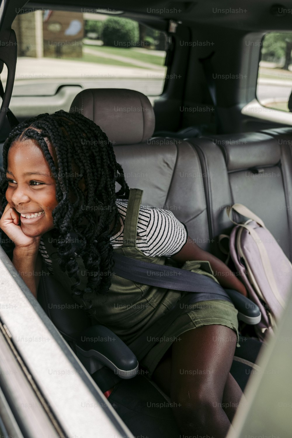 a woman sitting in the back seat of a car