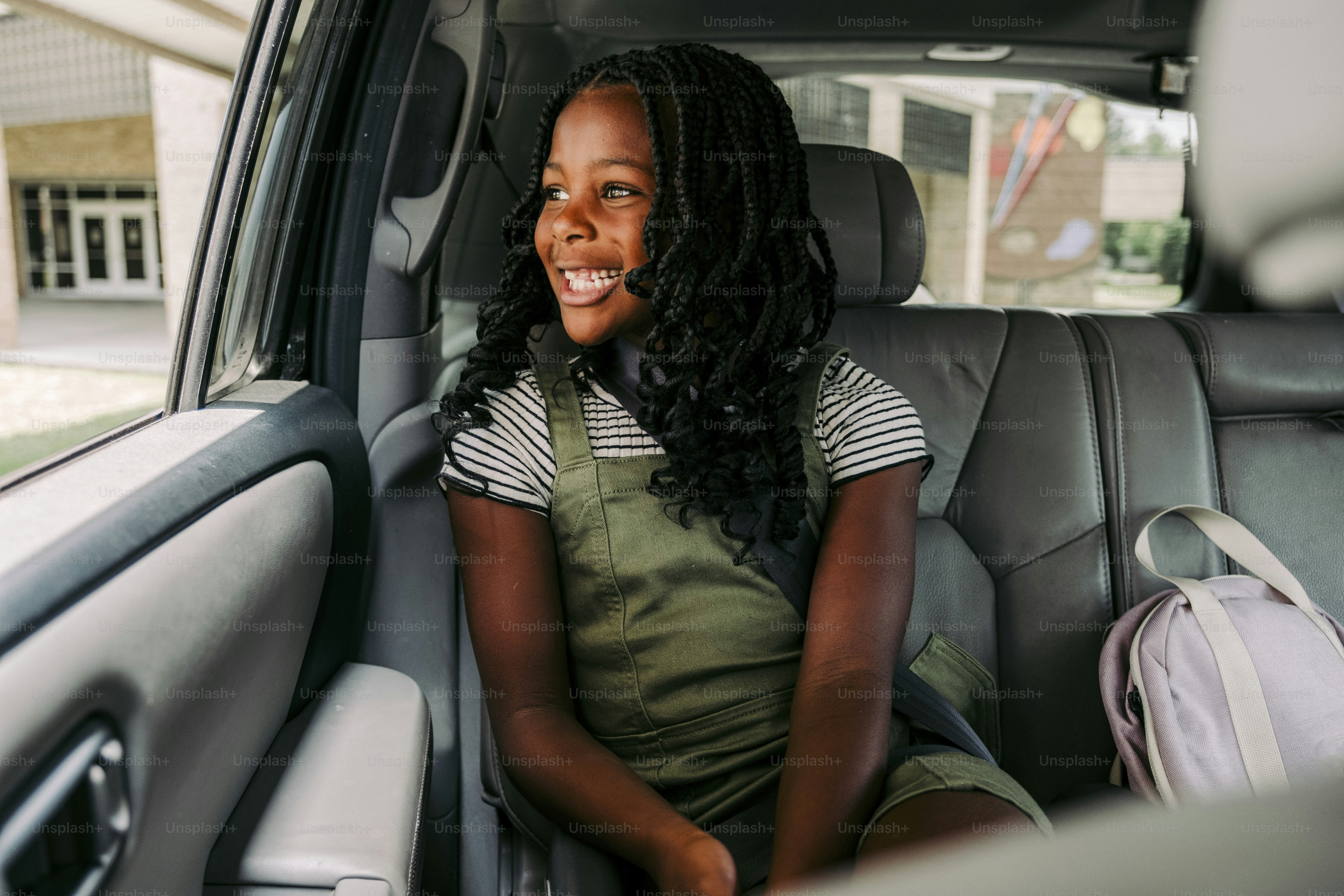 a woman sitting in the back seat of a car