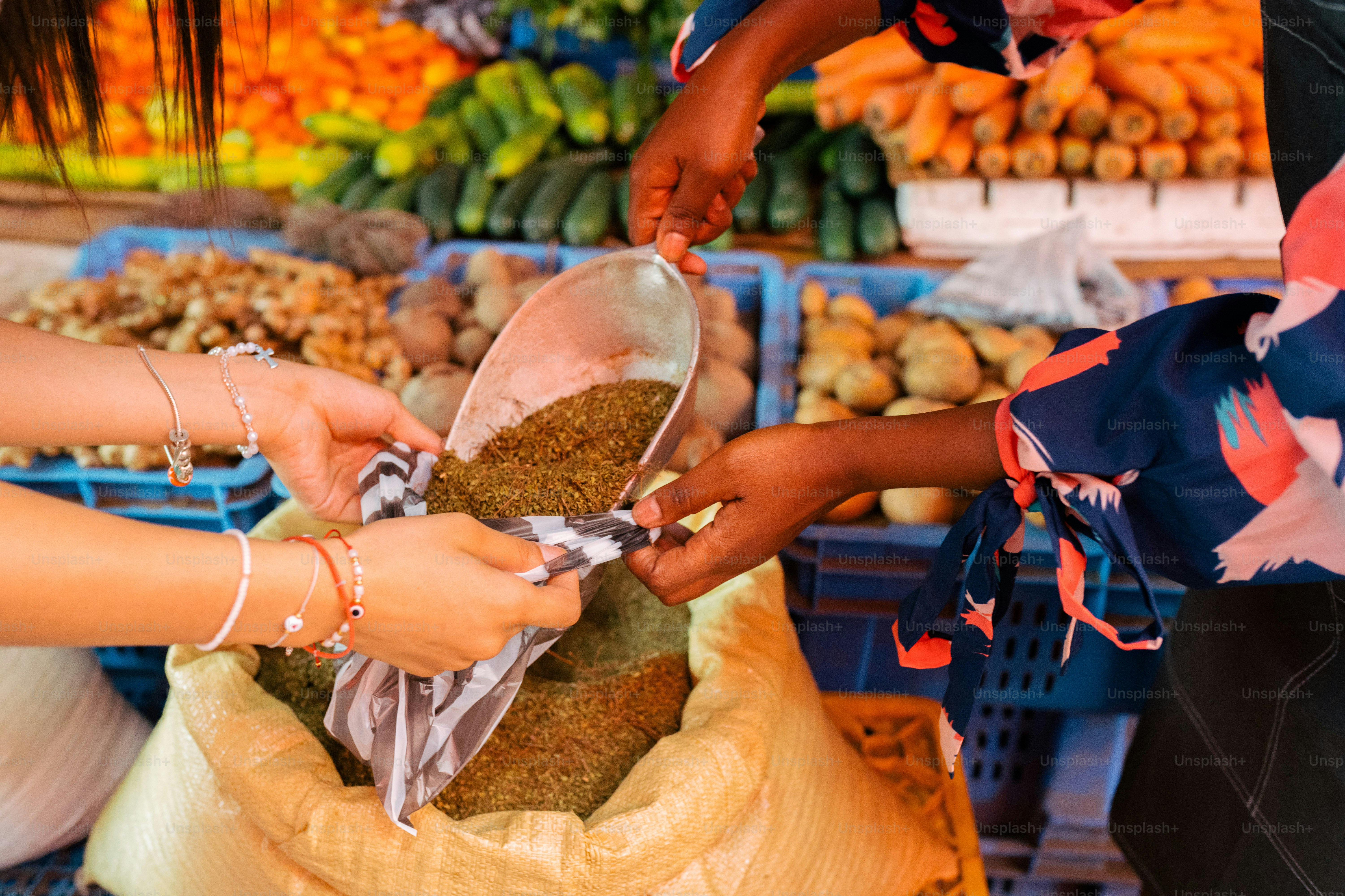 a group of people standing around a pile of food