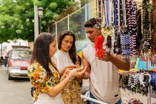 a man and two women looking at a necklace