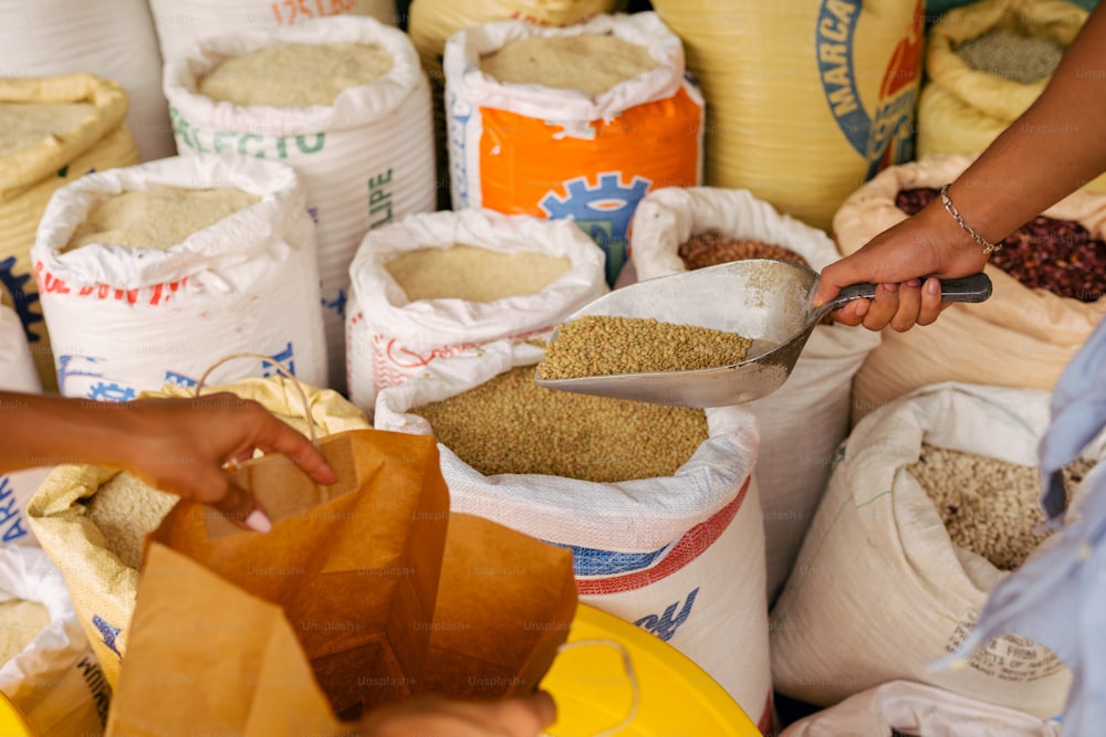 a person cutting a bag of food with a pair of scissors