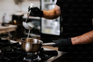 a man is stirring something in a pot on the stove