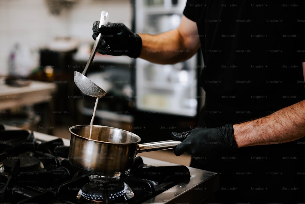 a man is stirring something in a pot on the stove