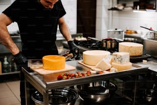 a man in a kitchen slicing cheese on a cutting board