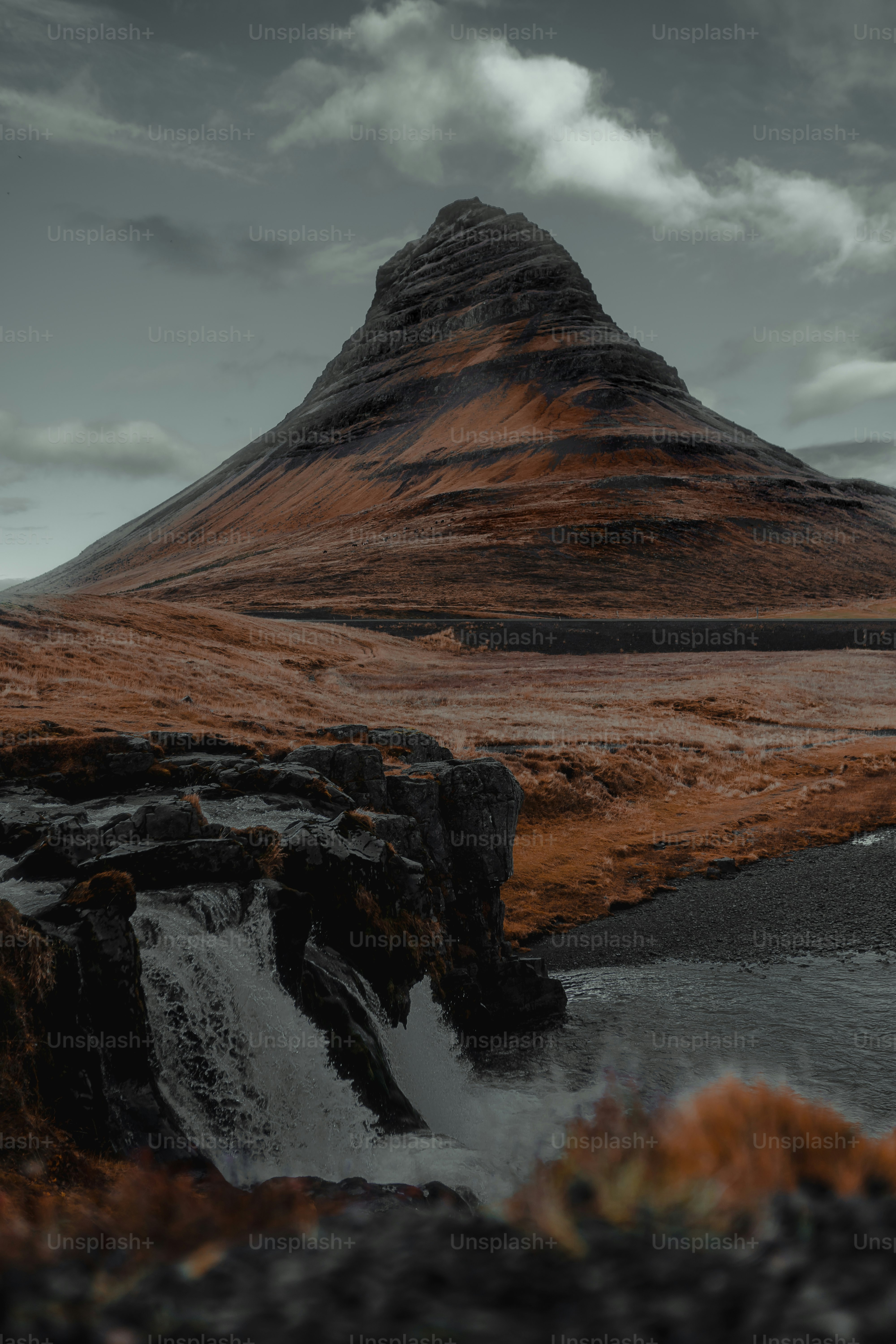 a mountain with a stream running through it