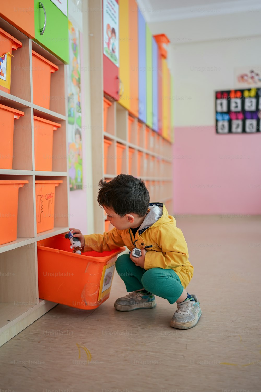 a little boy playing with a bucket in a library