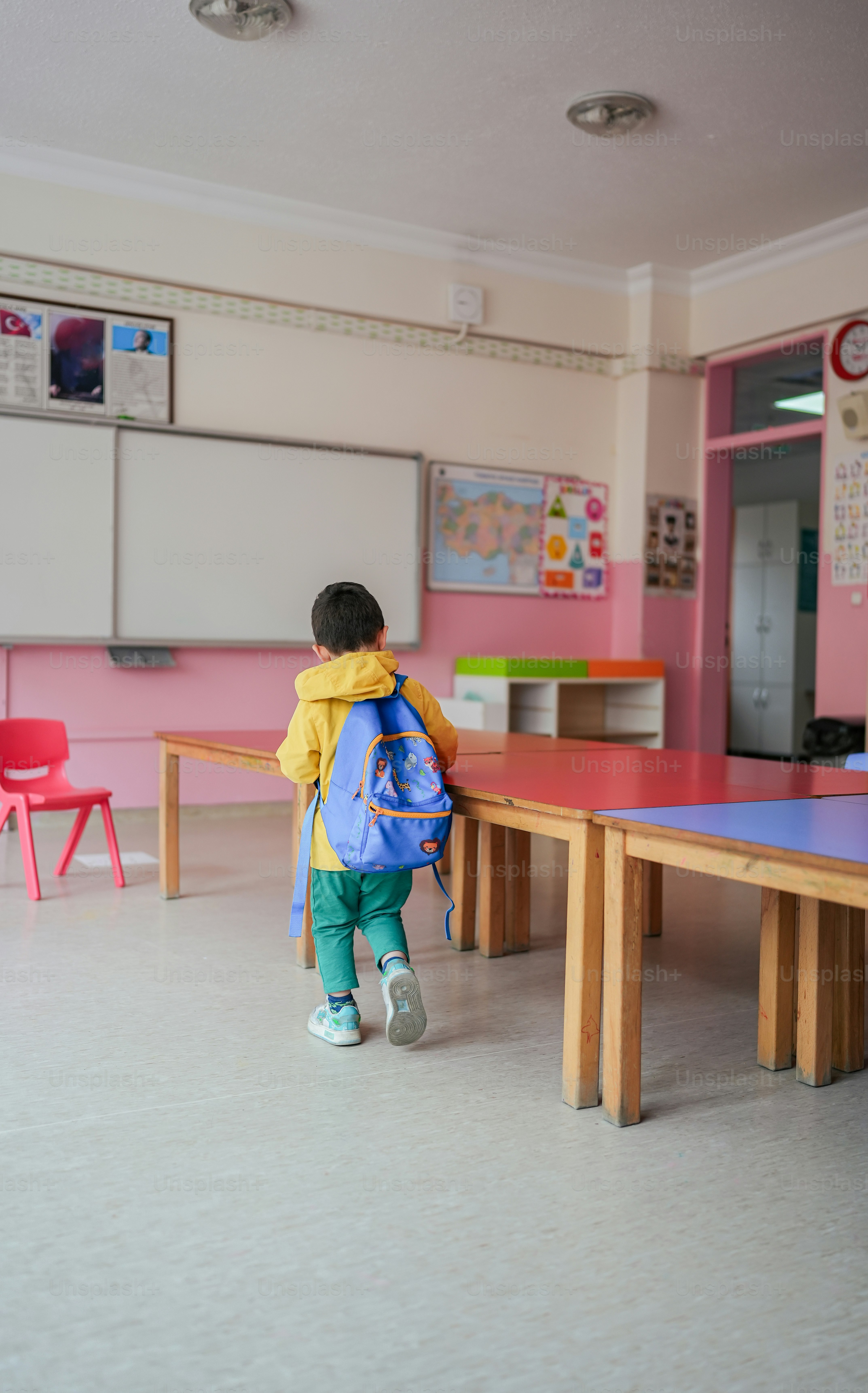a little boy that is standing in front of a ping pong table