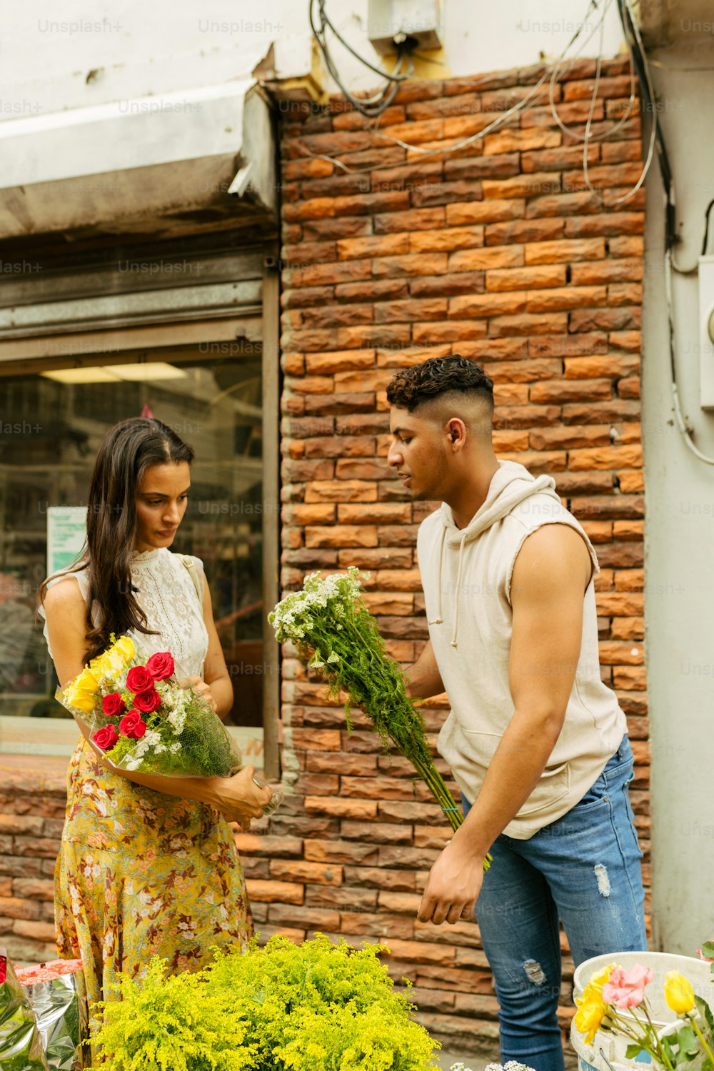 a man and a woman standing in front of a flower shop