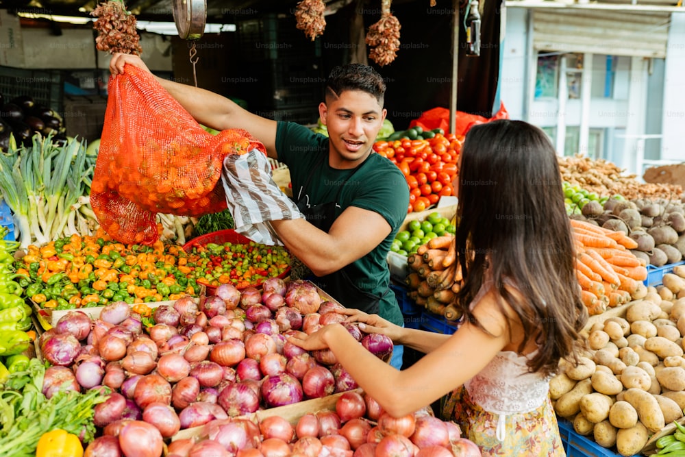 a man and a woman shopping at an outdoor market