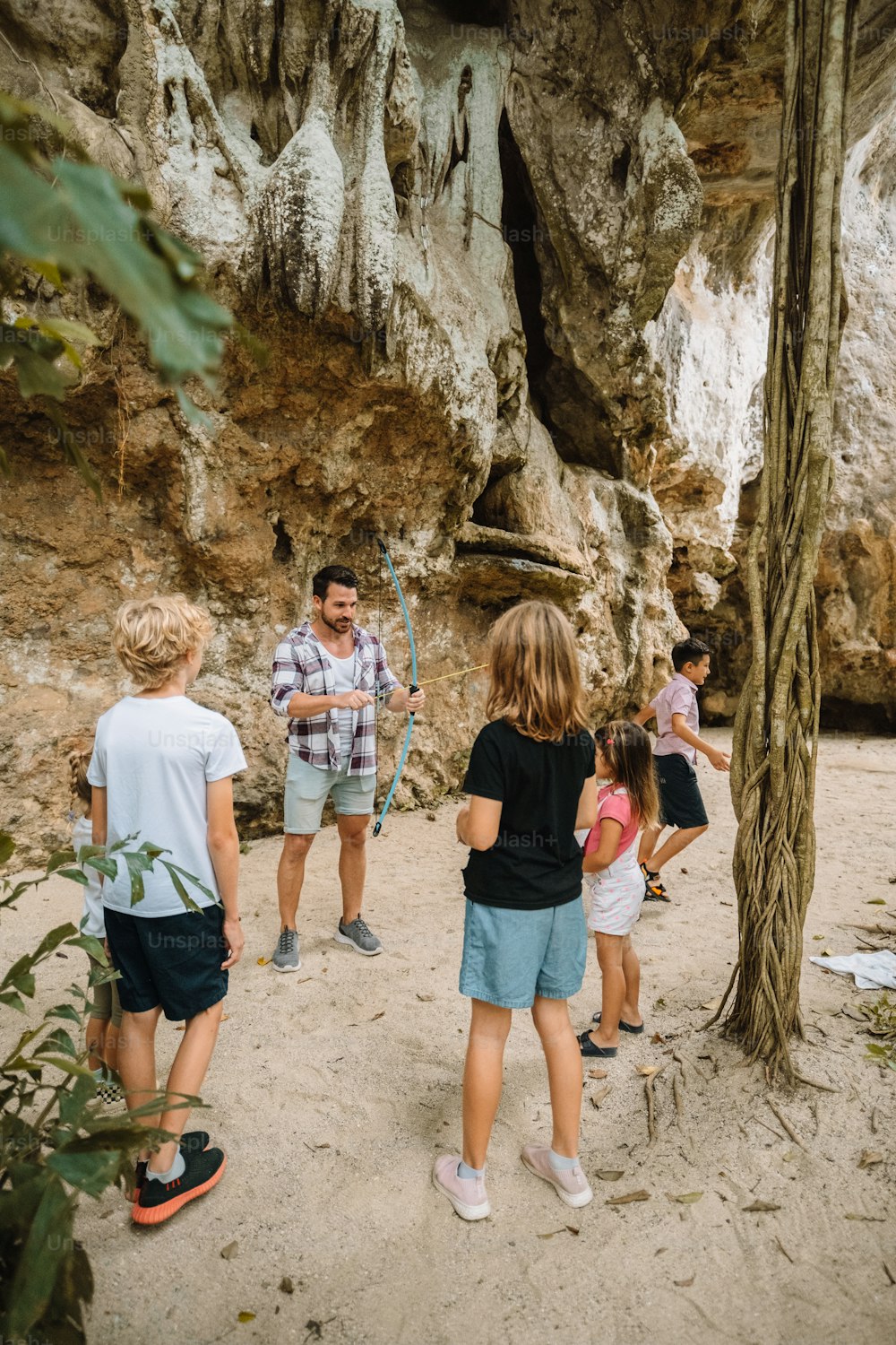 a group of people standing in front of a cave