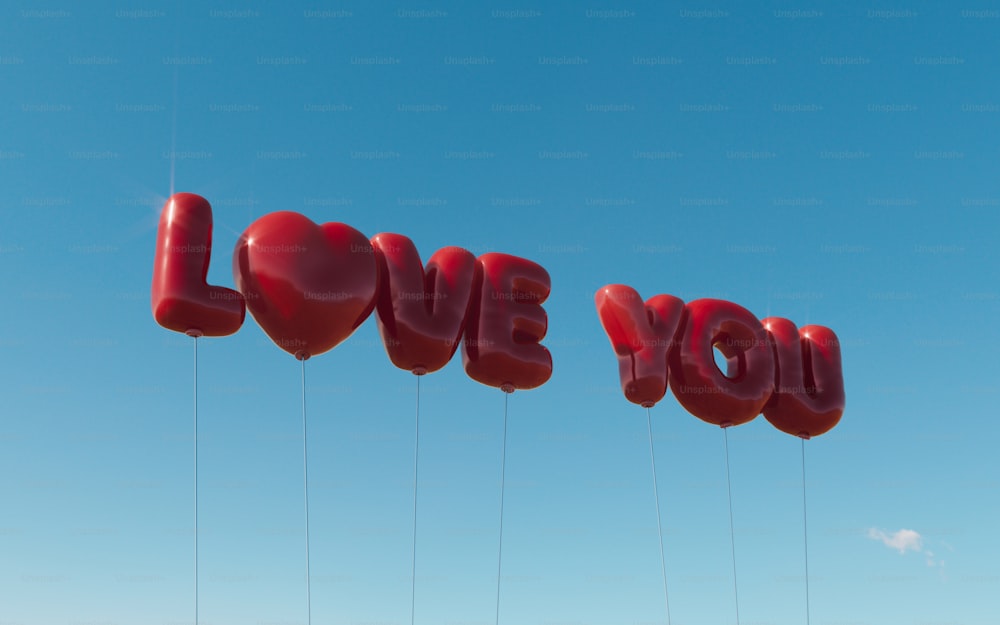 a couple of red balloons that say love you
