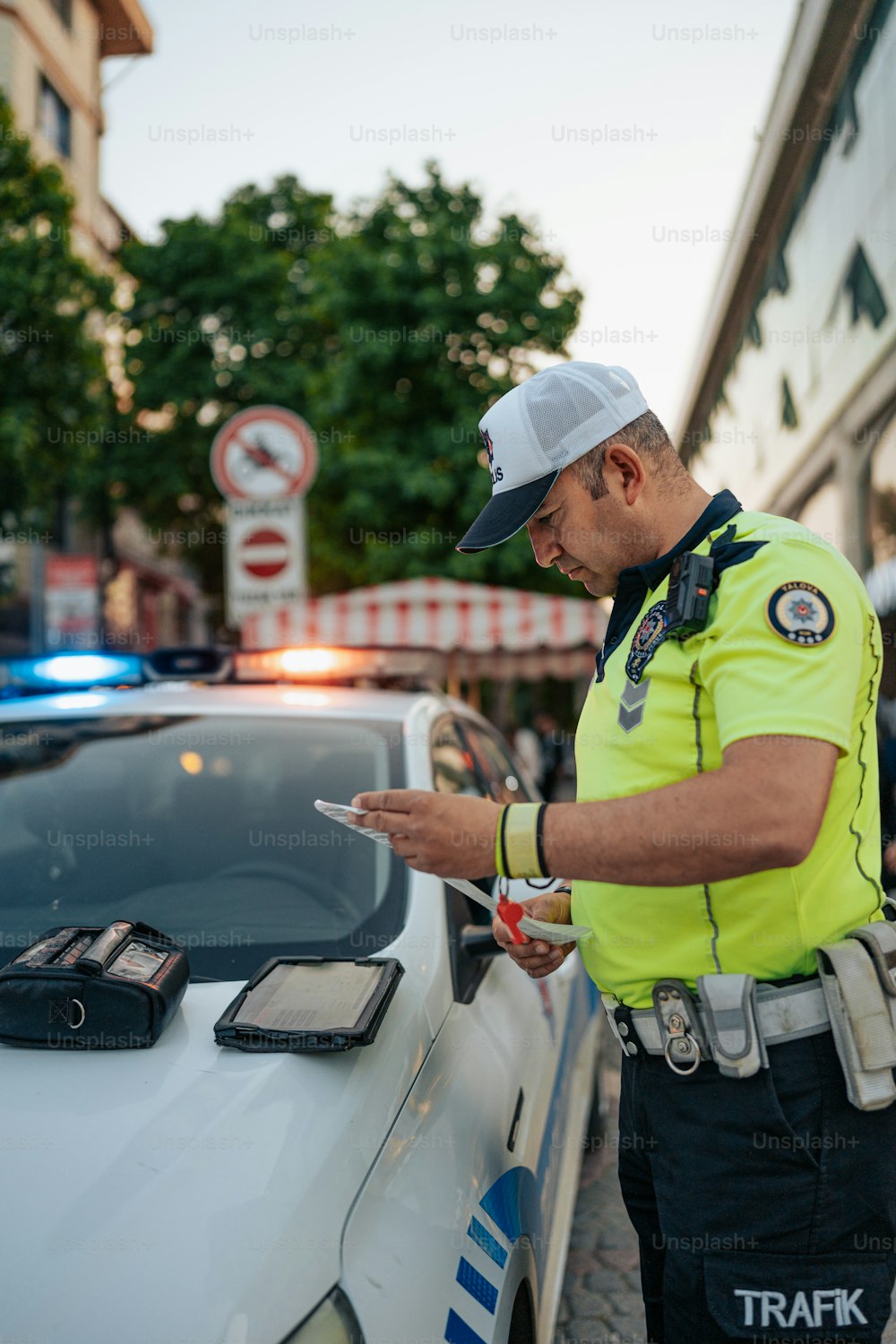 a police officer standing next to a police car