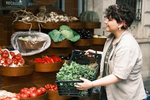 a woman holding a basket of vegetables in front of a store