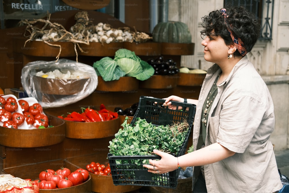a woman holding a basket of vegetables in front of a store