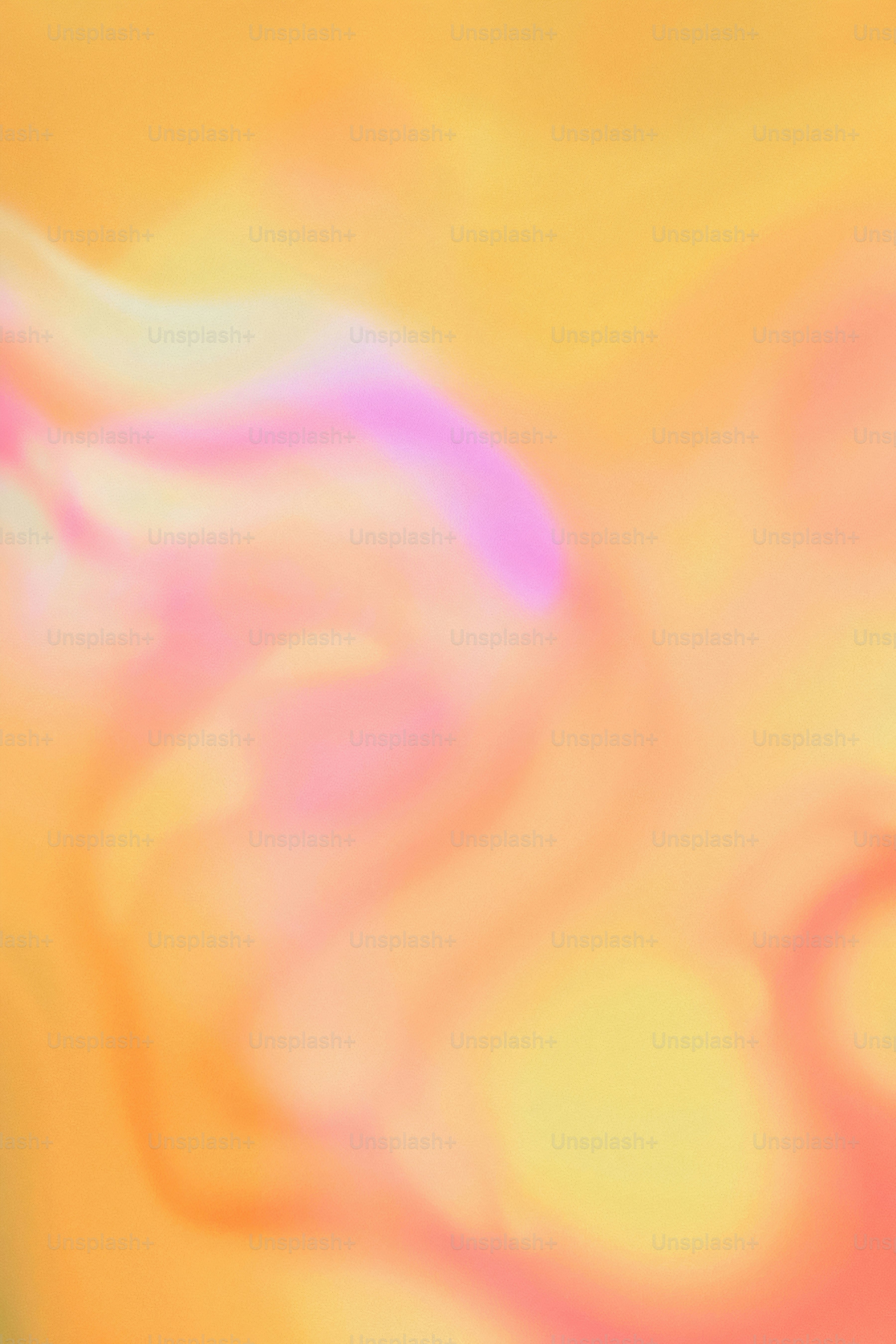 a blurry image of a yellow and pink background