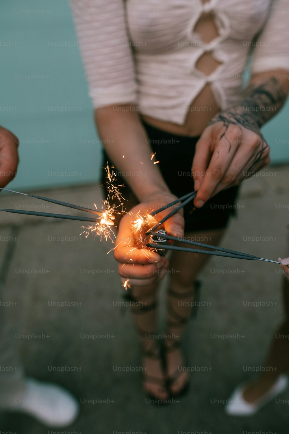 two people holding sparklers in their hands