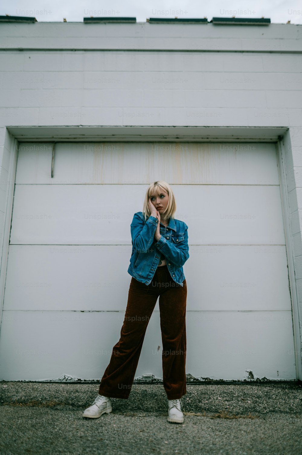 a woman standing in front of a garage door