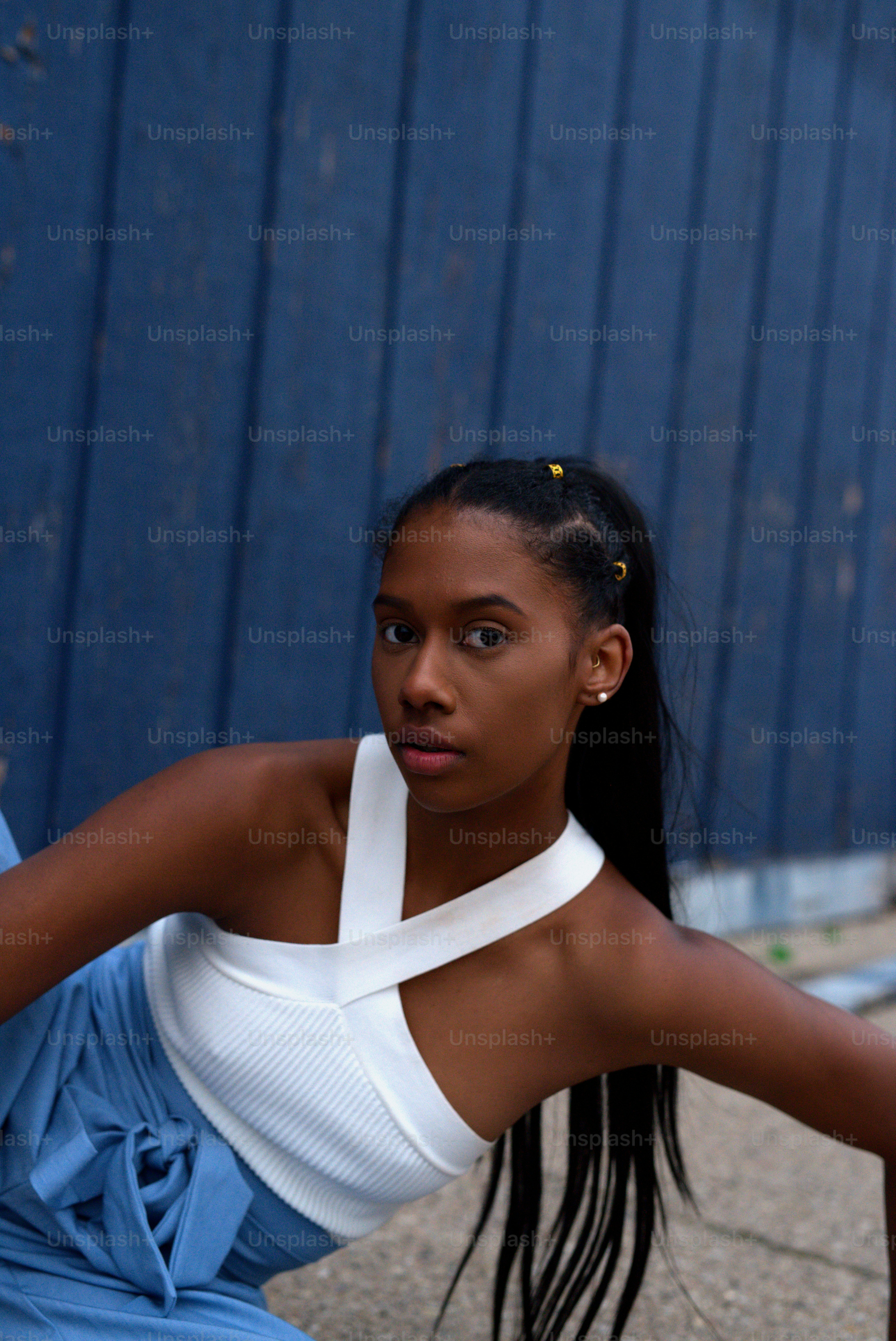 a woman is sitting on the ground with a tennis racket