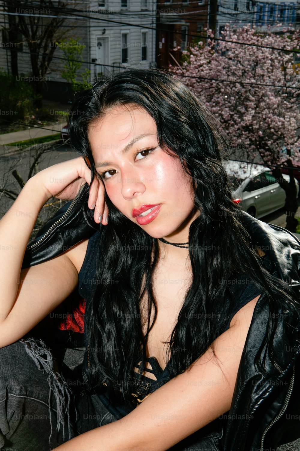 a woman with long black hair sitting on a motorcycle