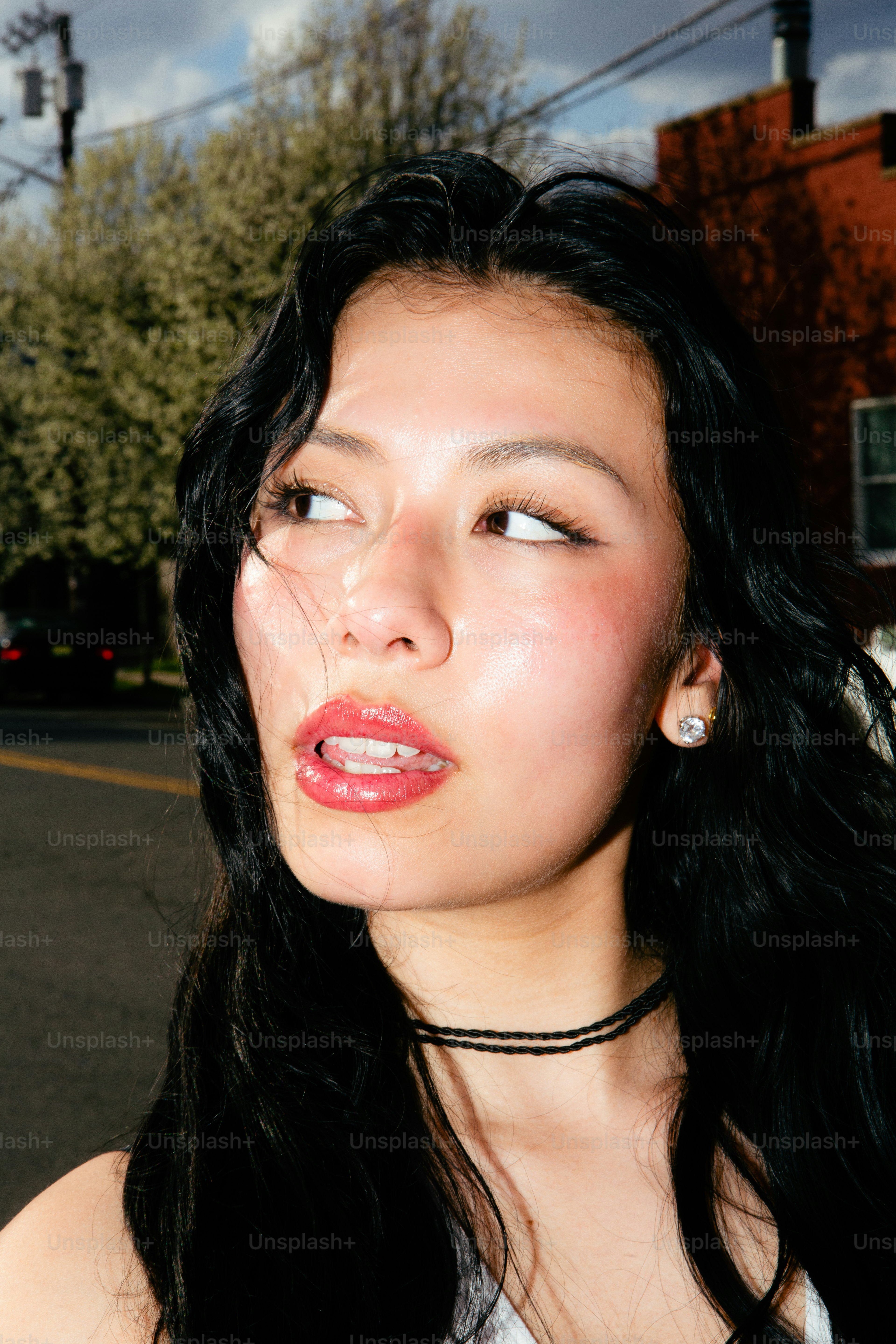 A woman with long black hair wearing a necklace photo – Woman Image on ...