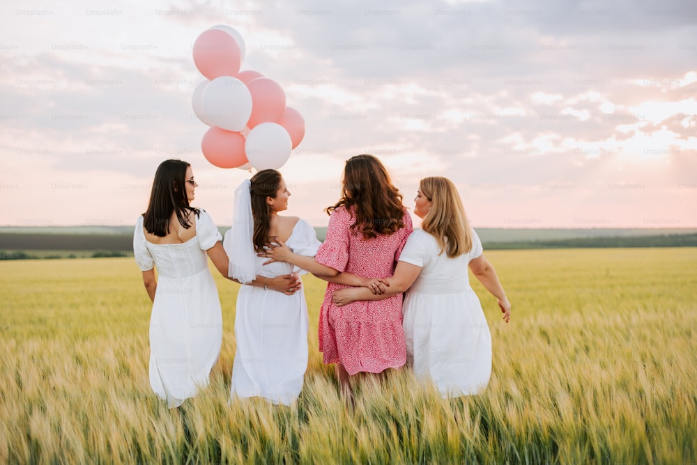 a group of women standing next to each other in a field